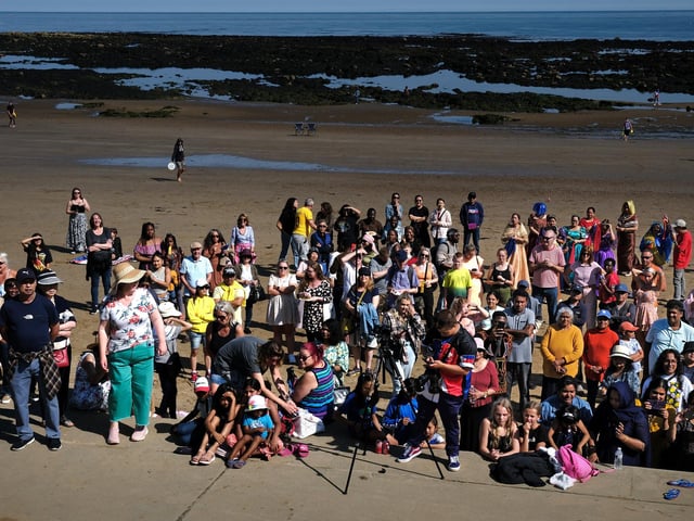 A large crowd gathered on the beach to enjoy the day