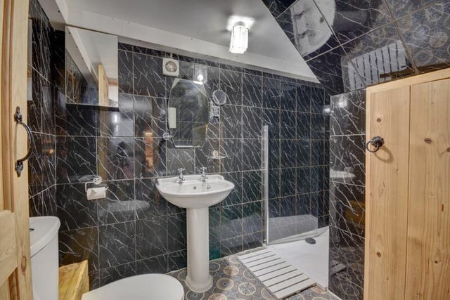 A modern bathroom with walk-in shower.