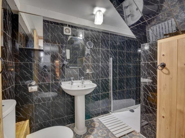 A modern bathroom with walk-in shower.