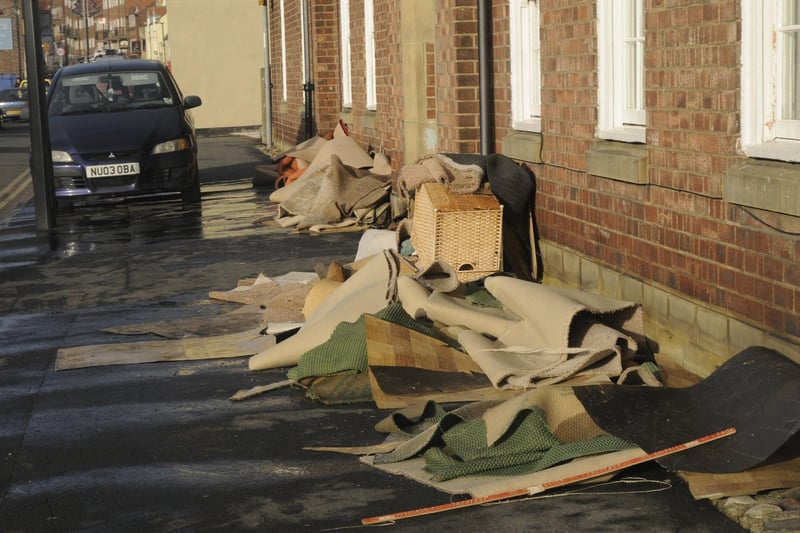 Ruined carpets and furniture on Whitby's Church Street after the floods.