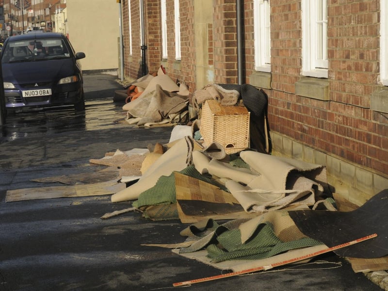 Ruined carpets and furniture on Whitby's Church Street after the floods.