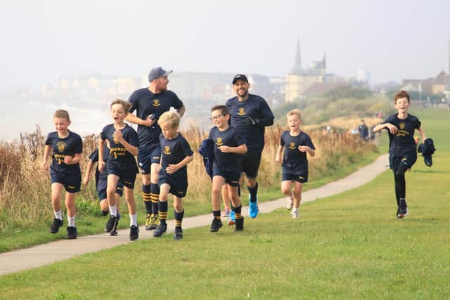 The Bridlington RUFC juniors and coaches tackle the Sewerby parkrun to raise funds for a trip away.
