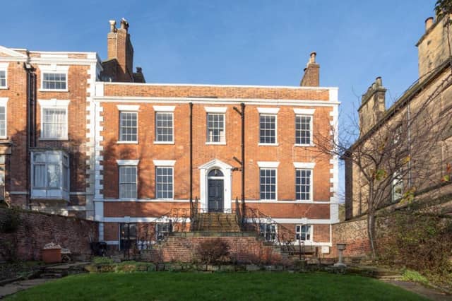 This imposing Georgian property is in one of central Whitby's most well regarded streets, and has gardens, a garage and parking spaces.