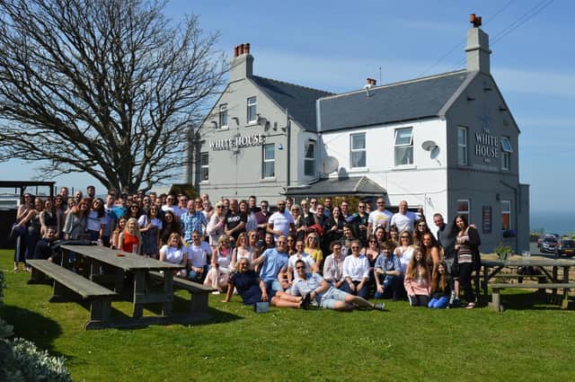 Drinkers at the 2024 Whitby pub crawl enjoy great weather outside at The White House, Whitby.
