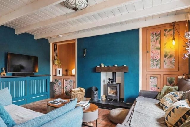 The beamed lounge with woodburner has built-in storage.
