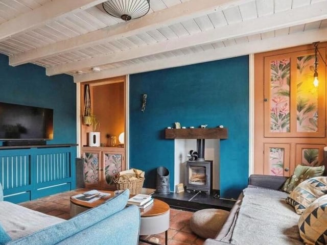 The beamed lounge with woodburner has built-in storage.