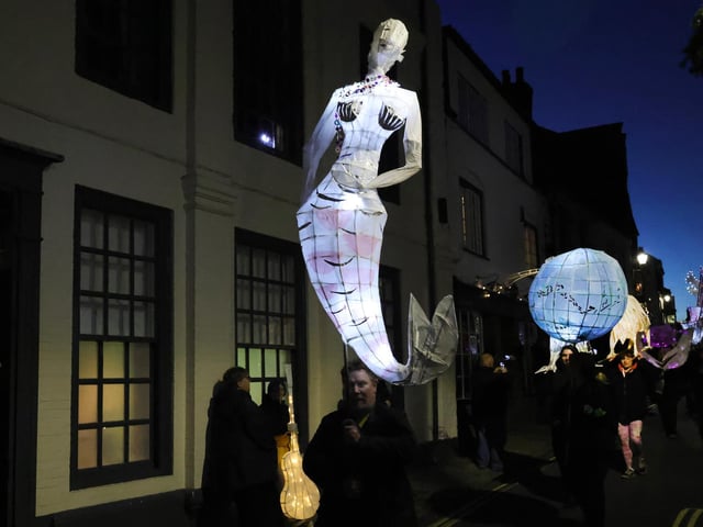 A beautiful mermaid sparkles in the night.