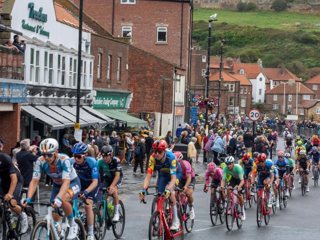 Cyclists make their way through the wet streets of Whitby.