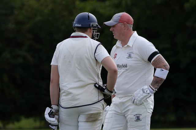 Seamer batters Archie Graham (wearing batting helmet) and Darrol Lewis have a chat during their home loss to Flixton 2nds
