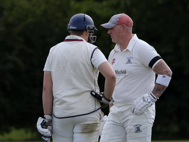 Seamer batters Archie Graham (wearing batting helmet) and Darrol Lewis have a chat during their home loss to Flixton 2nds