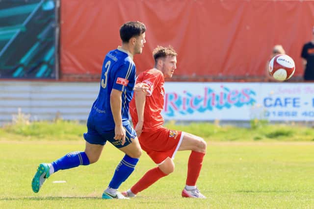 Casey Stewart takes the ball away from a Ferriby rival. Photo by TCF Photography