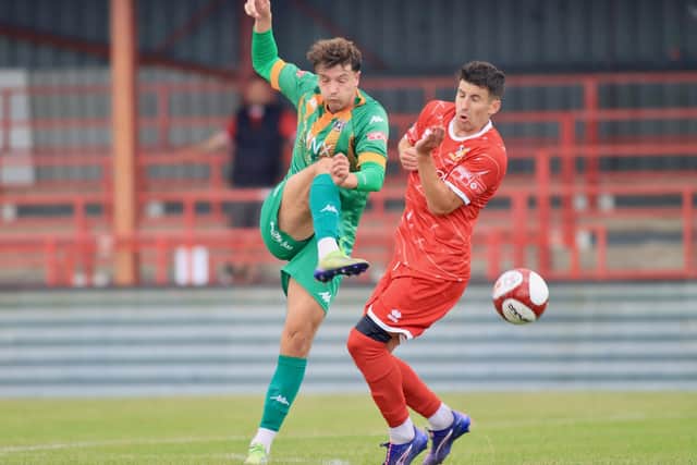 Brid forward Michael Coulson tries to block an Ashington clearance. Photo by TCF Photography