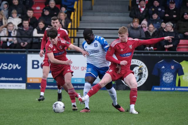 Boro's Cody Johnson, left, and Alex Wiles, right get stuck in against National League North leaders Tamworth. PHOTOS BY RICHARD PONTER