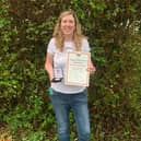 Sarah Monteith shows off her English Field Archery Association 3D Championships gold medal and national record certificate.
