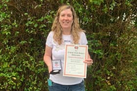 Sarah Monteith shows off her English Field Archery Association 3D Championships gold medal and national record certificate.