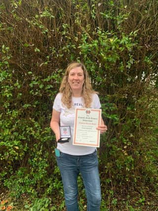 Sarah Monteith shows off her English Field Archery Association 3D Championships gold medal and national record certificate.