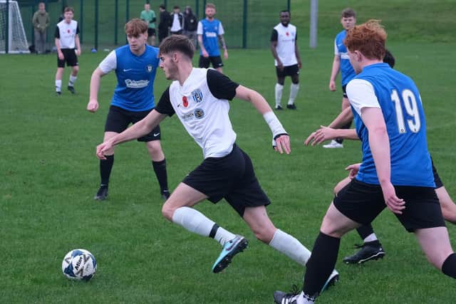 Scalby, white and black kit, on the attack during their win at derby rivals Newby. Photo by Richard Ponter