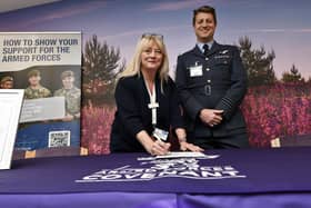 St Catherine's Hospice Michelle Muir signs the declaration with Wing Commander Thom Colledge.
picture: Richard Ponter