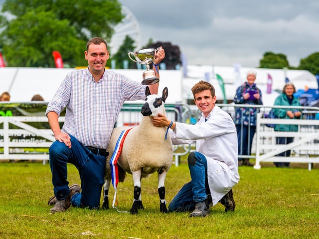 Chris Adamson, of Littleborough, owner of this year's Overall Championship Sheep, a Kerry Hill called 'Double Diamond' which also won breed Champion at the show, held by (right) sheep handler William Awan