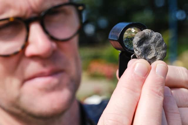 Dr Liam Herringshaw at Whitby Museum with the ‘garlic stones’. photo: Tony Bartholomew