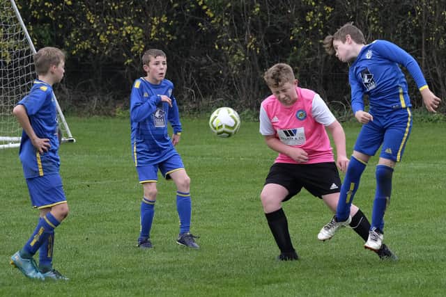 Eastfield Under-13s, blue kit, get stuck in against Ayton