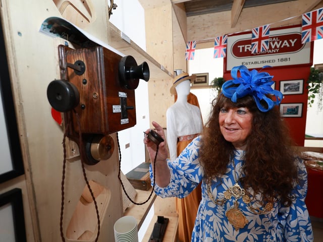 Mayor Janet Jefferson tries out one of the old phones