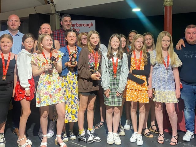 The Scarborough Ladies FC UNder-12s Reds show off their medals and trophies.
