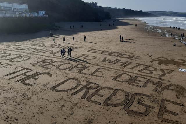 Protests in Whitby against the shellfish deaths included a message on the beach.