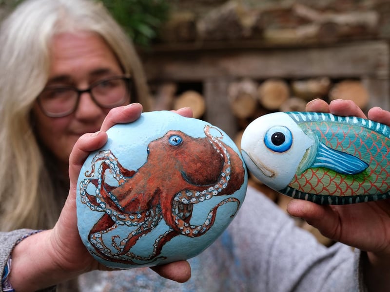 Artist Lucy Wilson with her stone art.