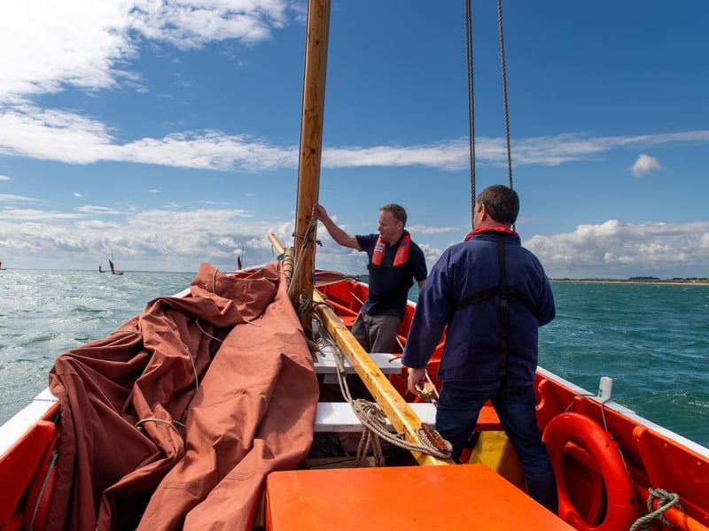 Chris Traves and Stewart McKie prepare to raise the sail of Imperialist.