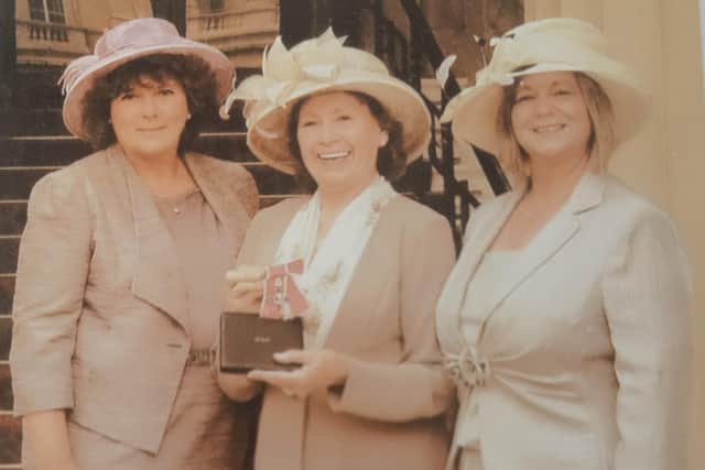 Barbara Benson-Smith receiving her MBE, with her daughter Liz Mills-Smith and Jeanette Allport Lilley.