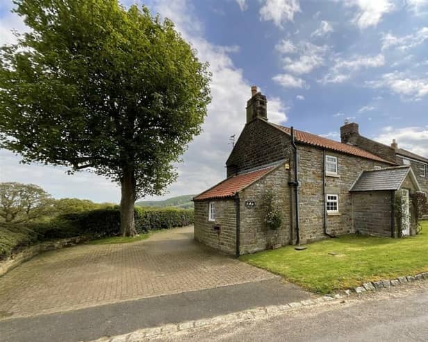 The approach to the appealing stone cottage in Harwood Vale.