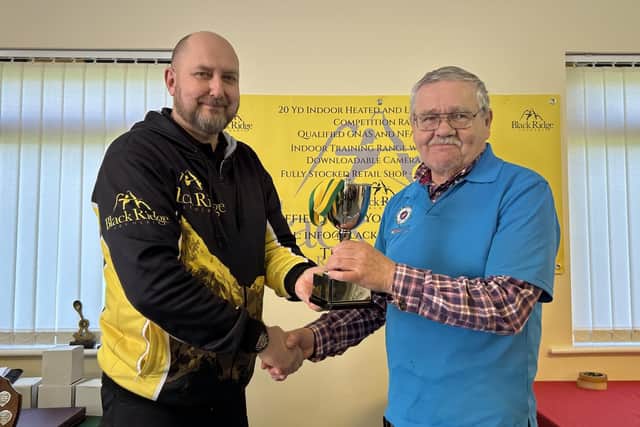 Simon Manning (Black Ridge Archery supplies) congratulates Gent Longbow Champion Patrick Revell.