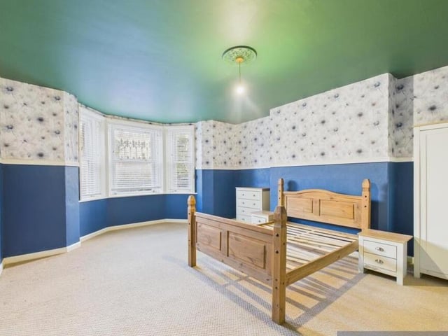 A spacious, bay-fronted bedroom.
