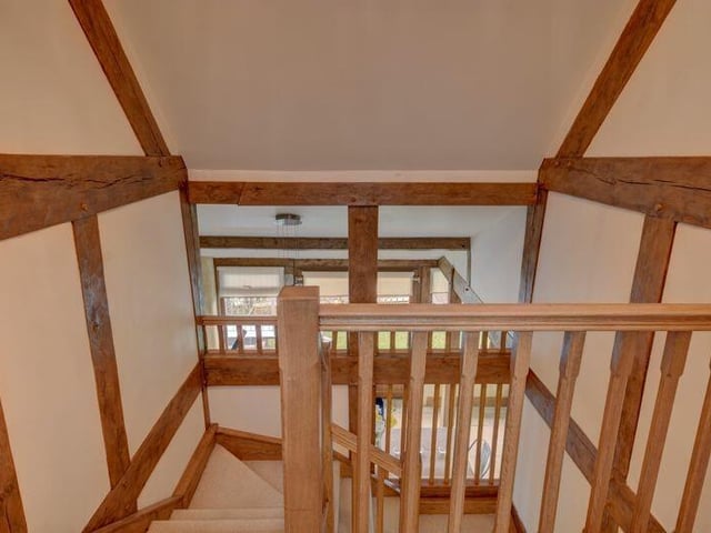 A view down the staircase from a gallery landing.