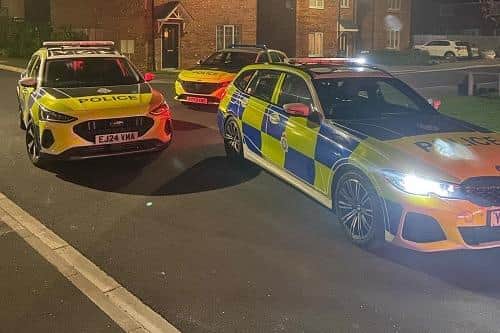 Police vehicles in front of houses in Boroughbridge.