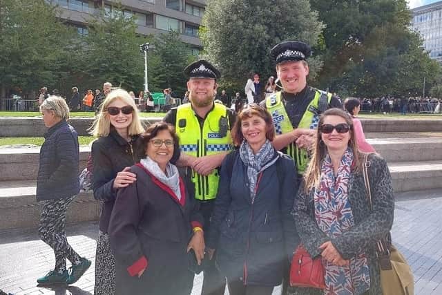 Sally-Ann with some of the friends she made in the queue and a couple of smiling policemen
