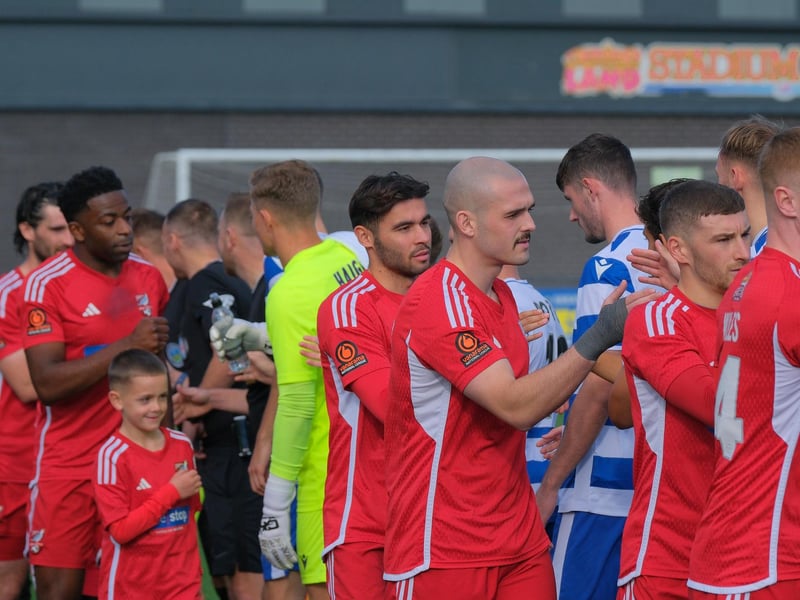 The players shake hands before the kick-off.
