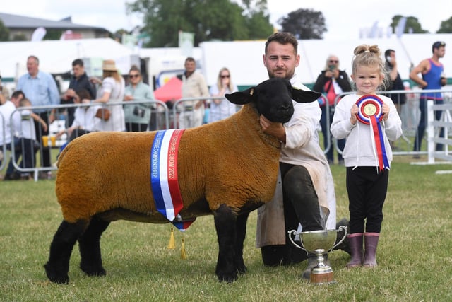 Tom and Celia Boden (aged six) with their Suffolk Sheep which was crowned Overall Sheep Supreme Champion at the show