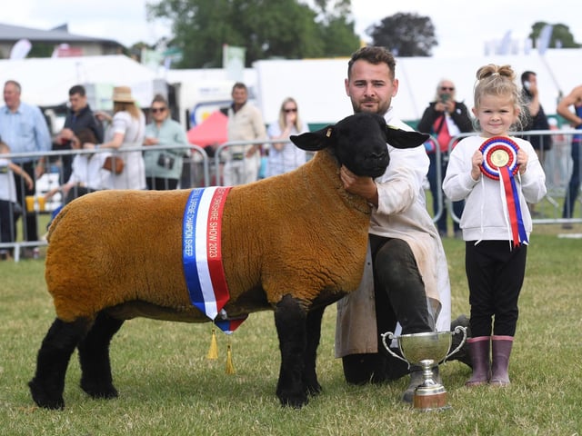 Tom and Celia Boden (aged six) with their Suffolk Sheep which was crowned Overall Sheep Supreme Champion at the show