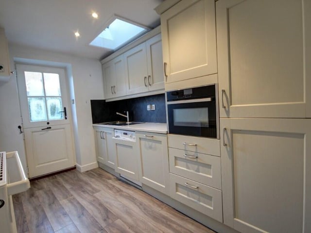 A utility room has fitted units and appliances.