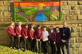 Glaisdale School youngsters and Acting Head Andrew Wood with the colourful mural they created.