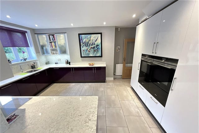 The modern, spacious kitchen with diner has integrated appliances.
