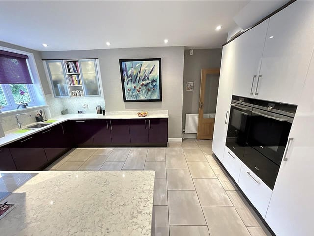 The modern, spacious kitchen with diner has integrated appliances.
