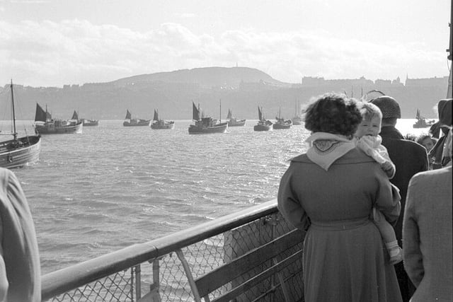 The boats are believed to be Dutch herring boats waiting to get into the harbour, in the 1950s.