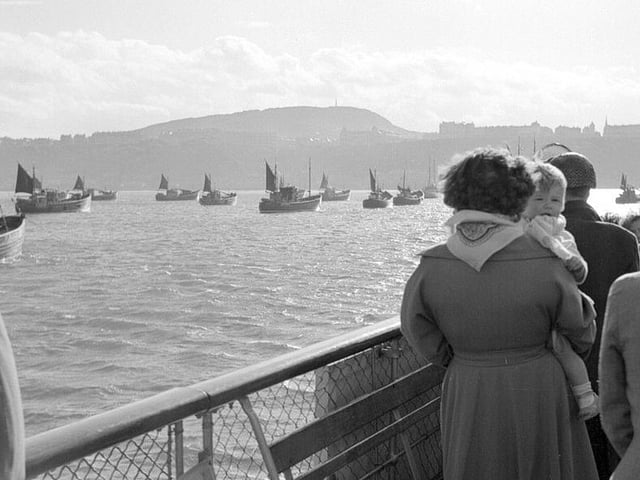 The boats are believed to be Dutch herring boats waiting to get into the harbour, in the 1950s.