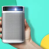 The XGIMI MoGo Pro 1080p portable projector is a compact, neat, curved-edge unit of white and silver. Image XGIMI