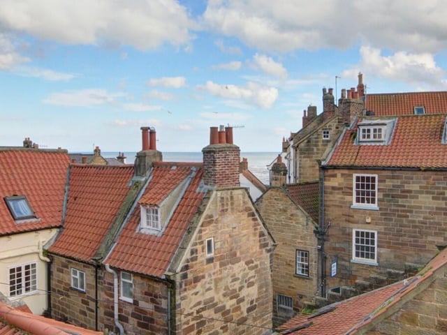 A view over rooftops and out to sea.