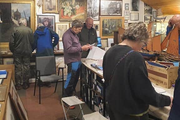 People browing the exhibits at Staithes Museum.