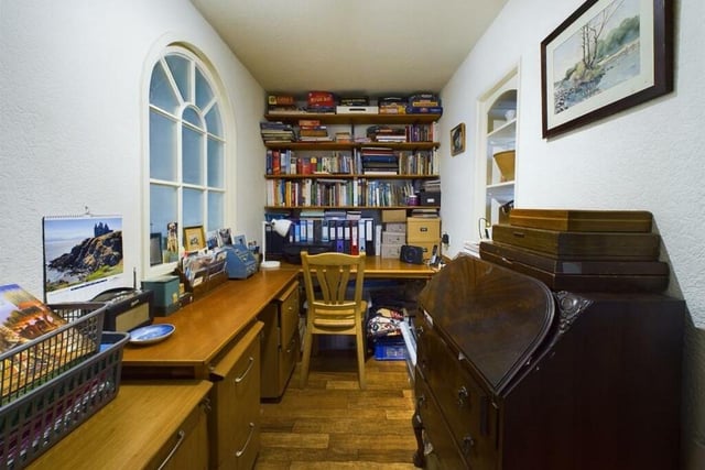A useful study or home office with arched window feature.